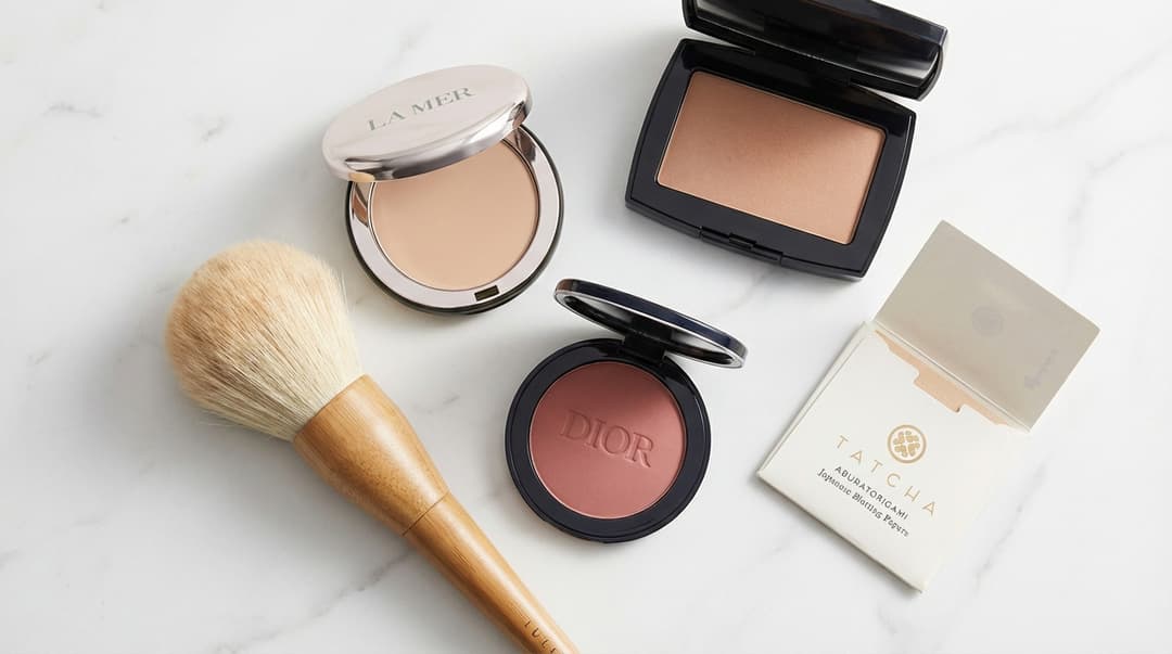 Flatlay of powder makeup products and tools for oil control