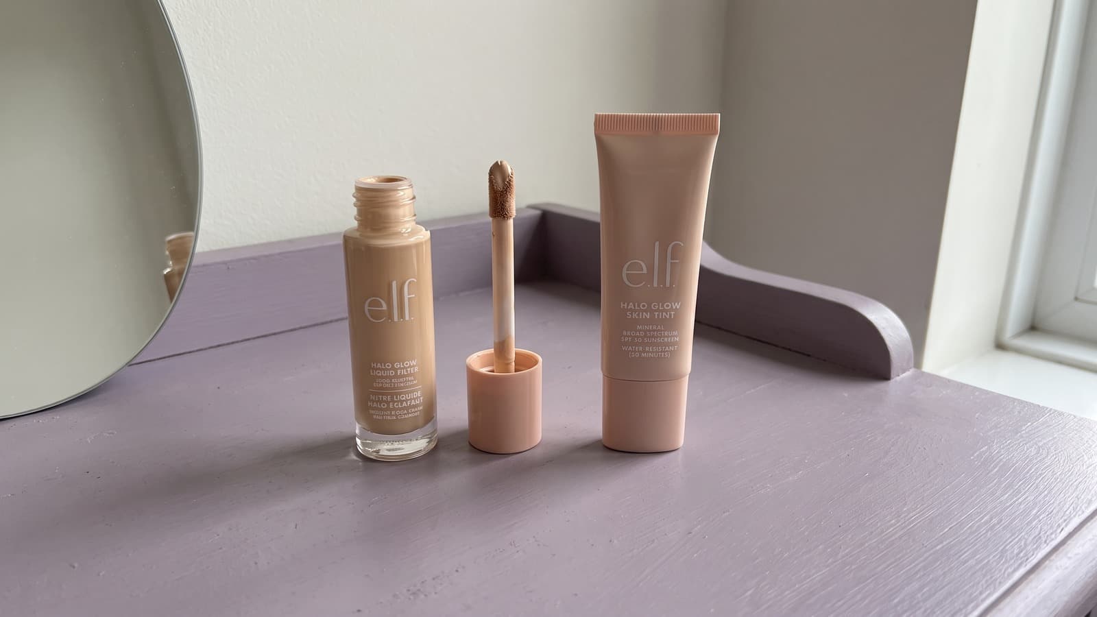 e.l.f. Halo Glow Liquid Filter and Skin Tint SPF 50 on a lilac dressing table